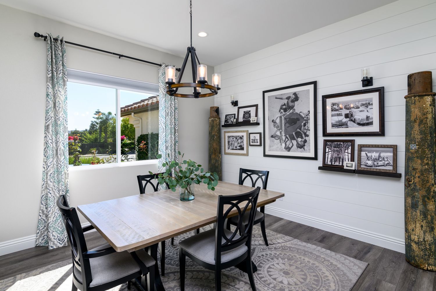 image shows an Artistic Dining Room with a table, 4 chairs, a light fixture and framed pictures on the wall, Newbury Park, CA  Kitchen Remodel 