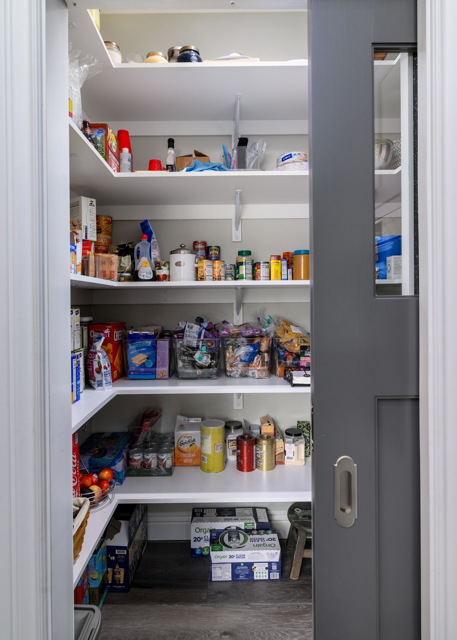 image shows a small walk-in kitchen pantry with packages of food on the shelves, Newbury Park, CA  Kitchen Remodel 
