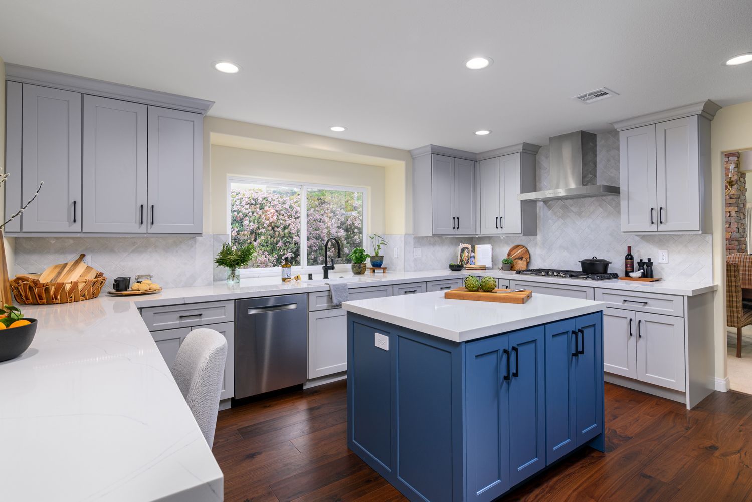 image of a beautiful kitchen with an island, blue and cool light gray cabinetry, white quartz countertops, stainless steel hood, dark hardwood floors, Camarillo, CA Kitchen Remodel 
