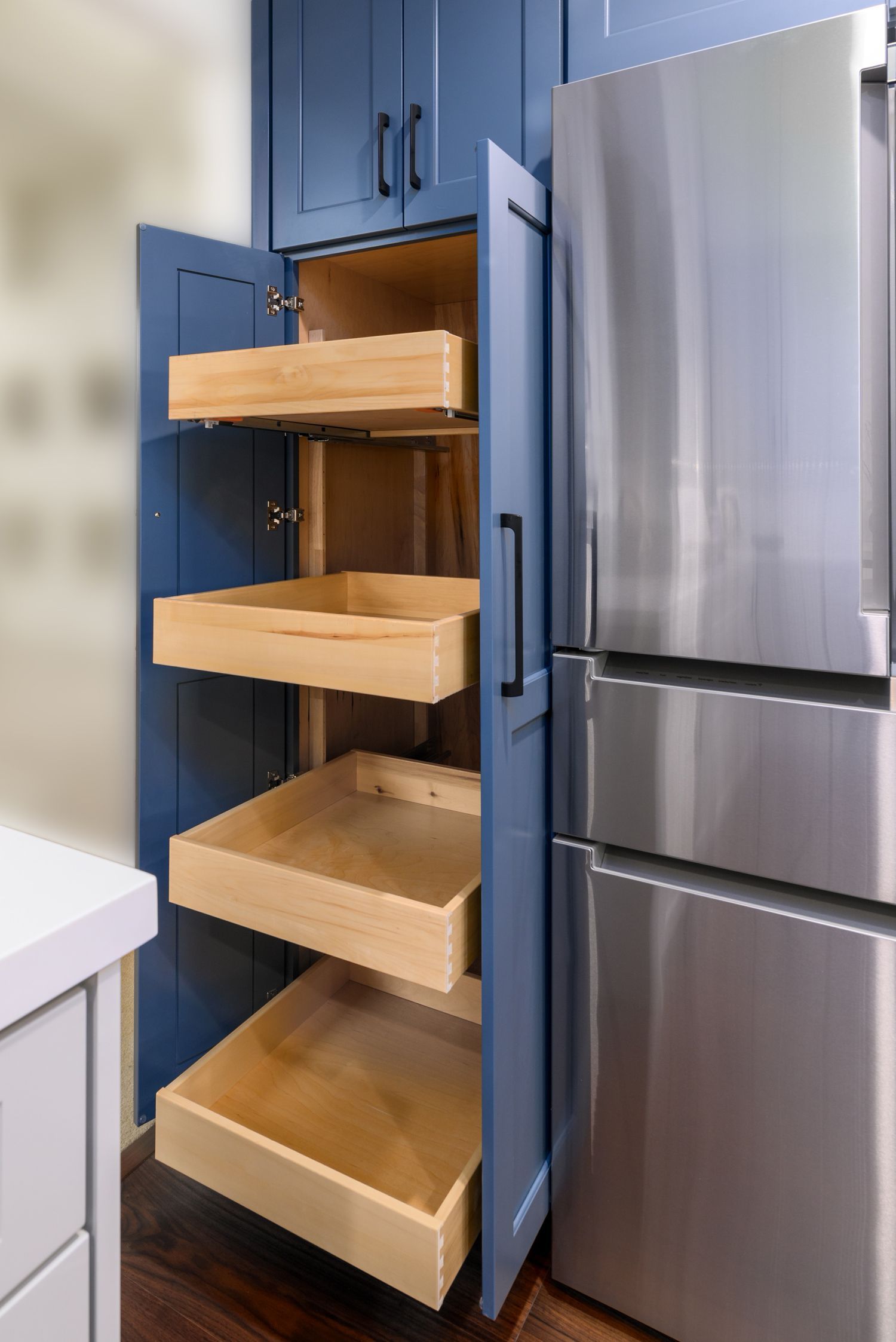 roll out pantry in bright blue cabinets, stainless steel refrigerator, Camarillo, Ca kitchen remodel 