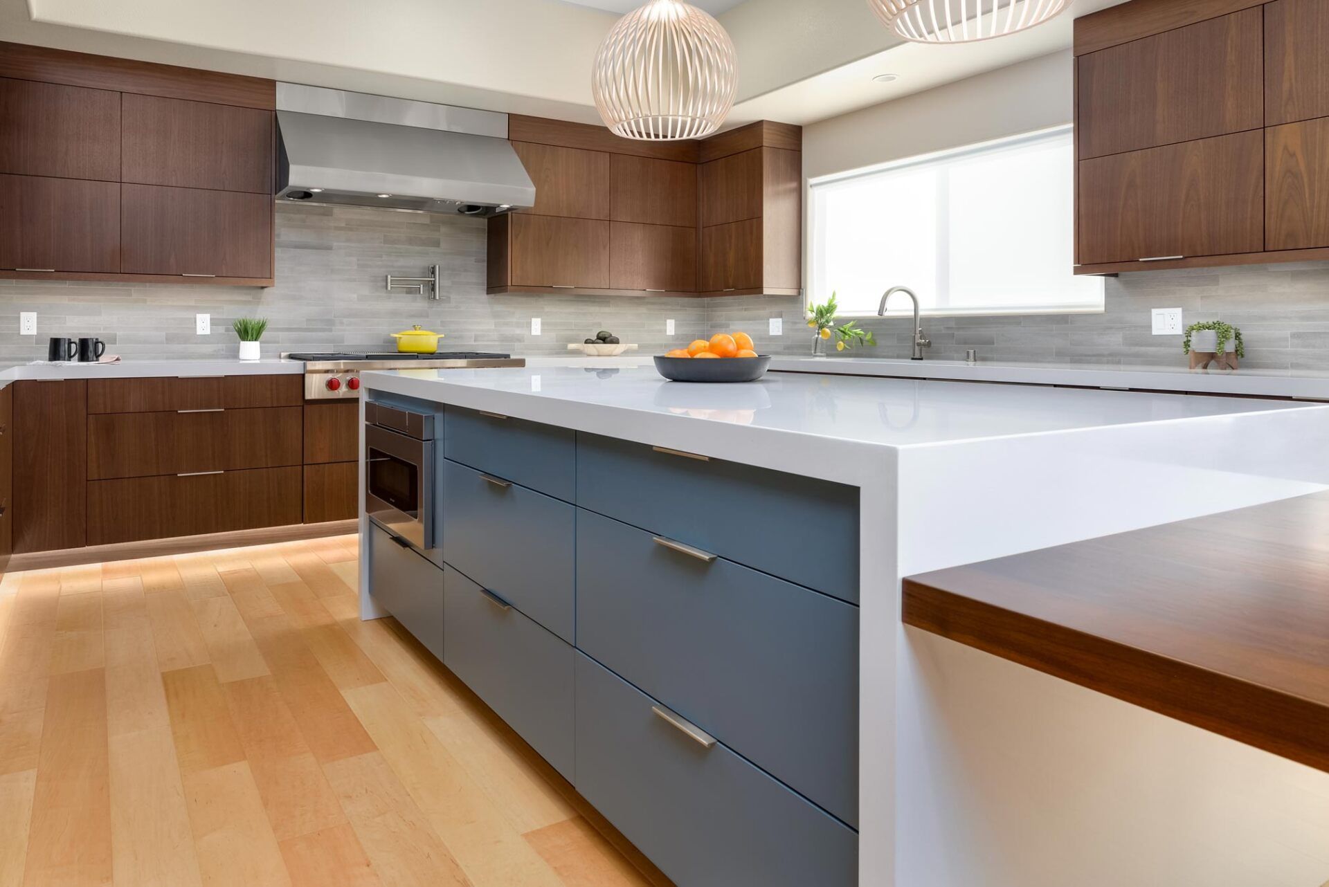 A kitchen with a large island and wooden cabinets