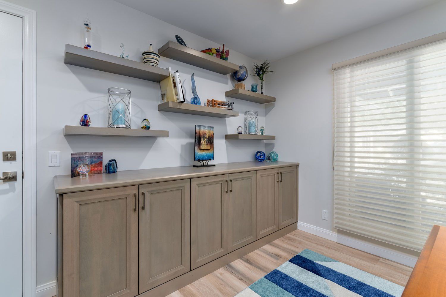 image shows light wood cabinetry by Omega, luxury vinyl flooring and floating shelves, West Hills, CA home remodel 