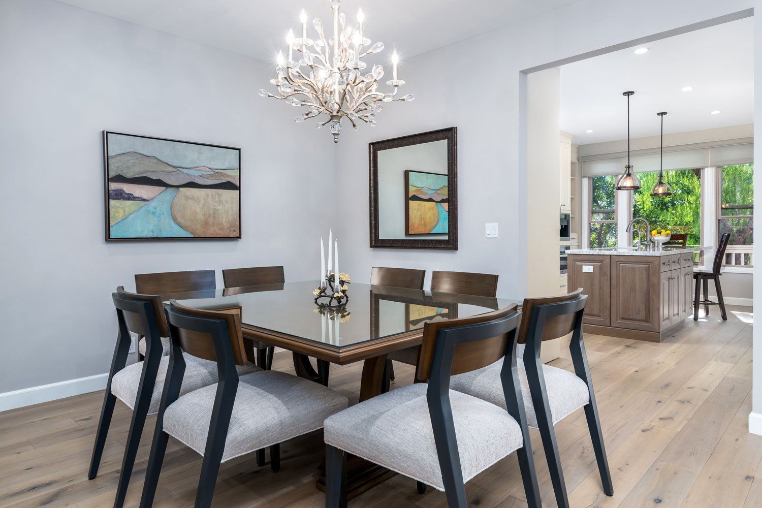 dining room with stylish table and chairs, sparkly crystal chandelier and hardwood floors, Westlake Village, CA condo remodel