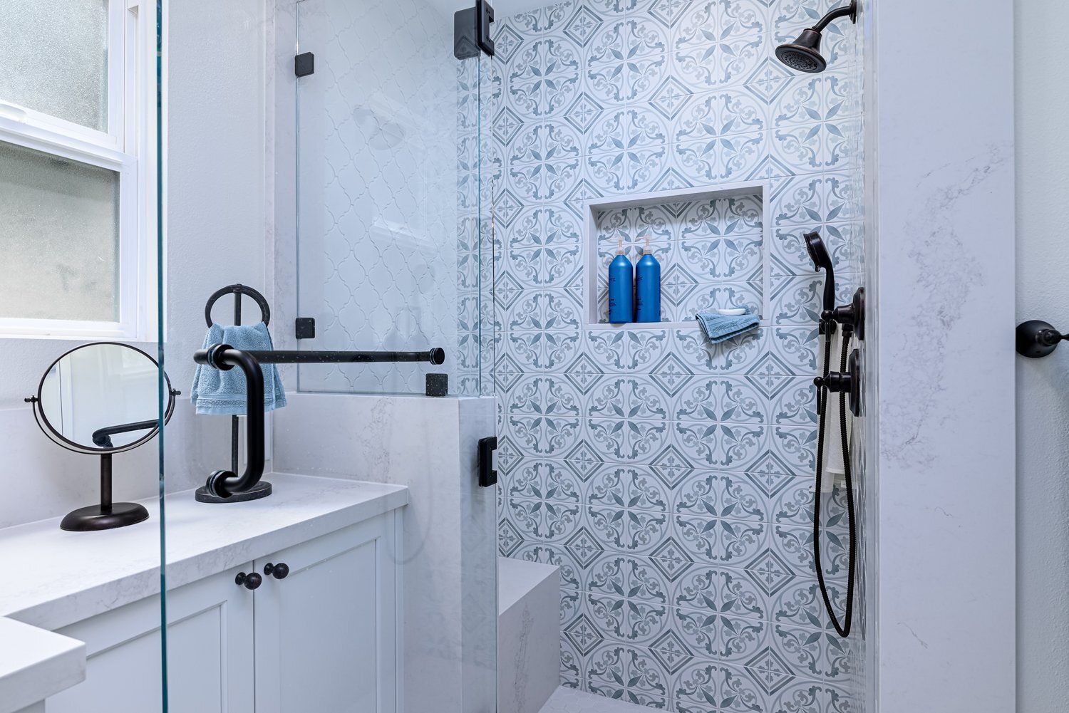 shower with blue and white Moroccan style tile, swinging shower door in primary-master bathroom remodel, Thousand Oaks, CA