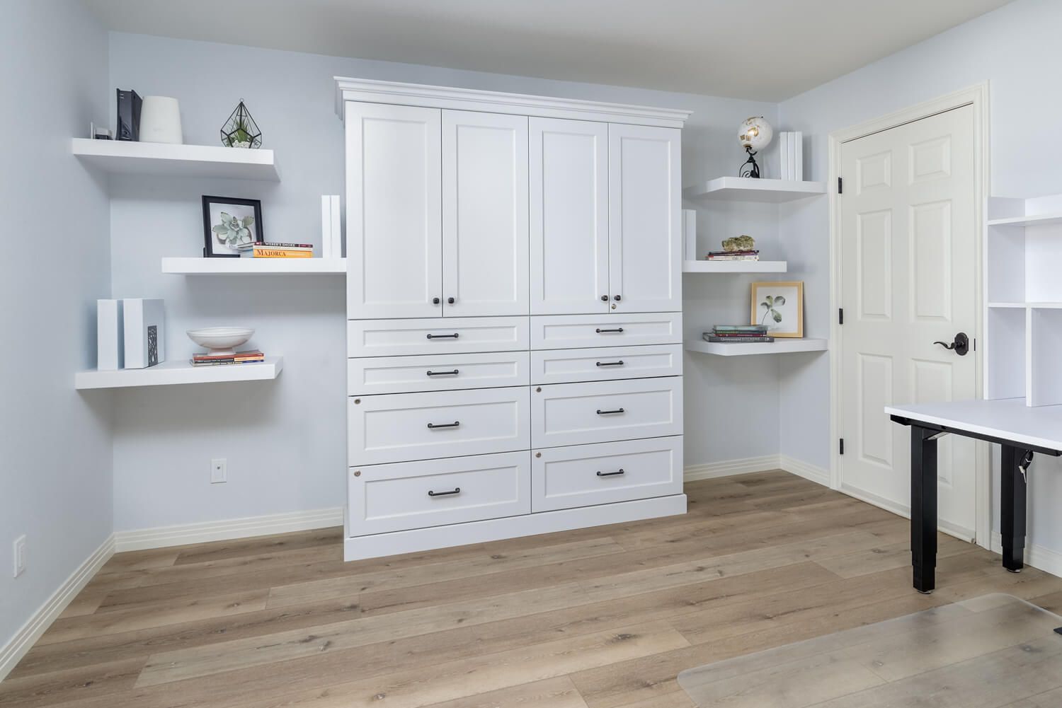 white Home Office Cabinet unit centered between floating shelves with decorations on them, luxury vinyl flooring, Santa Rosa Valley, CA Home Office Remodel