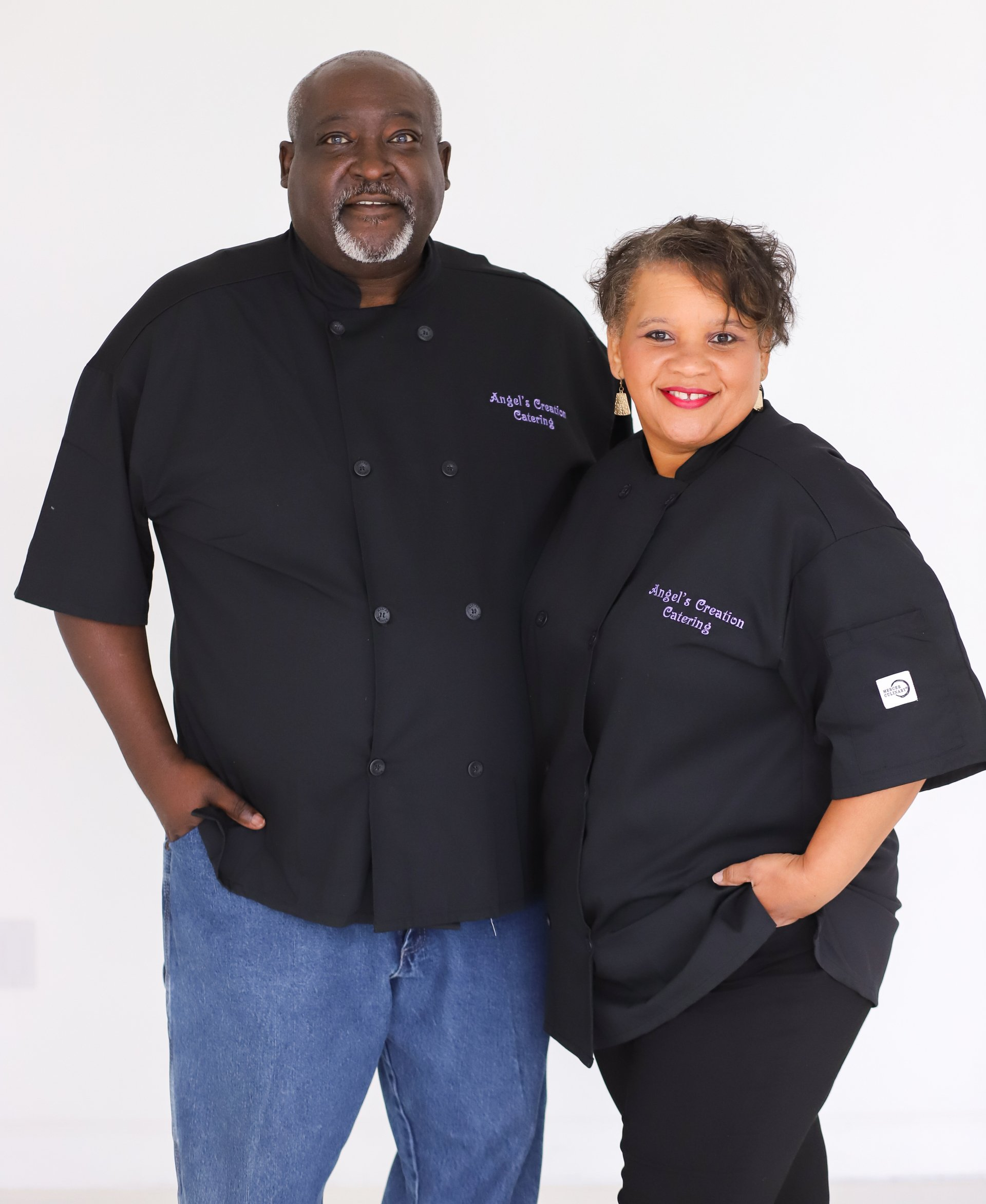 A man and a woman standing next to each other with their hands in their pockets