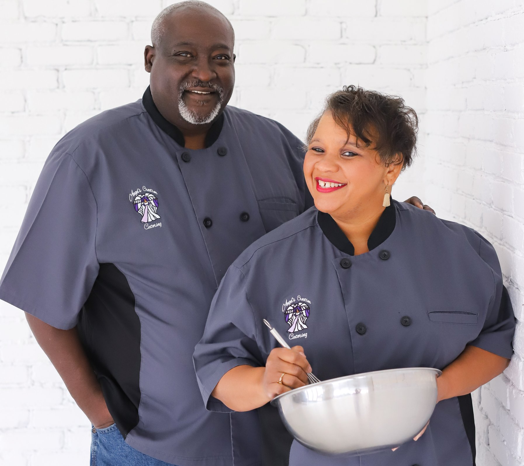 A man and a woman are posing for a picture and the woman is holding a bowl