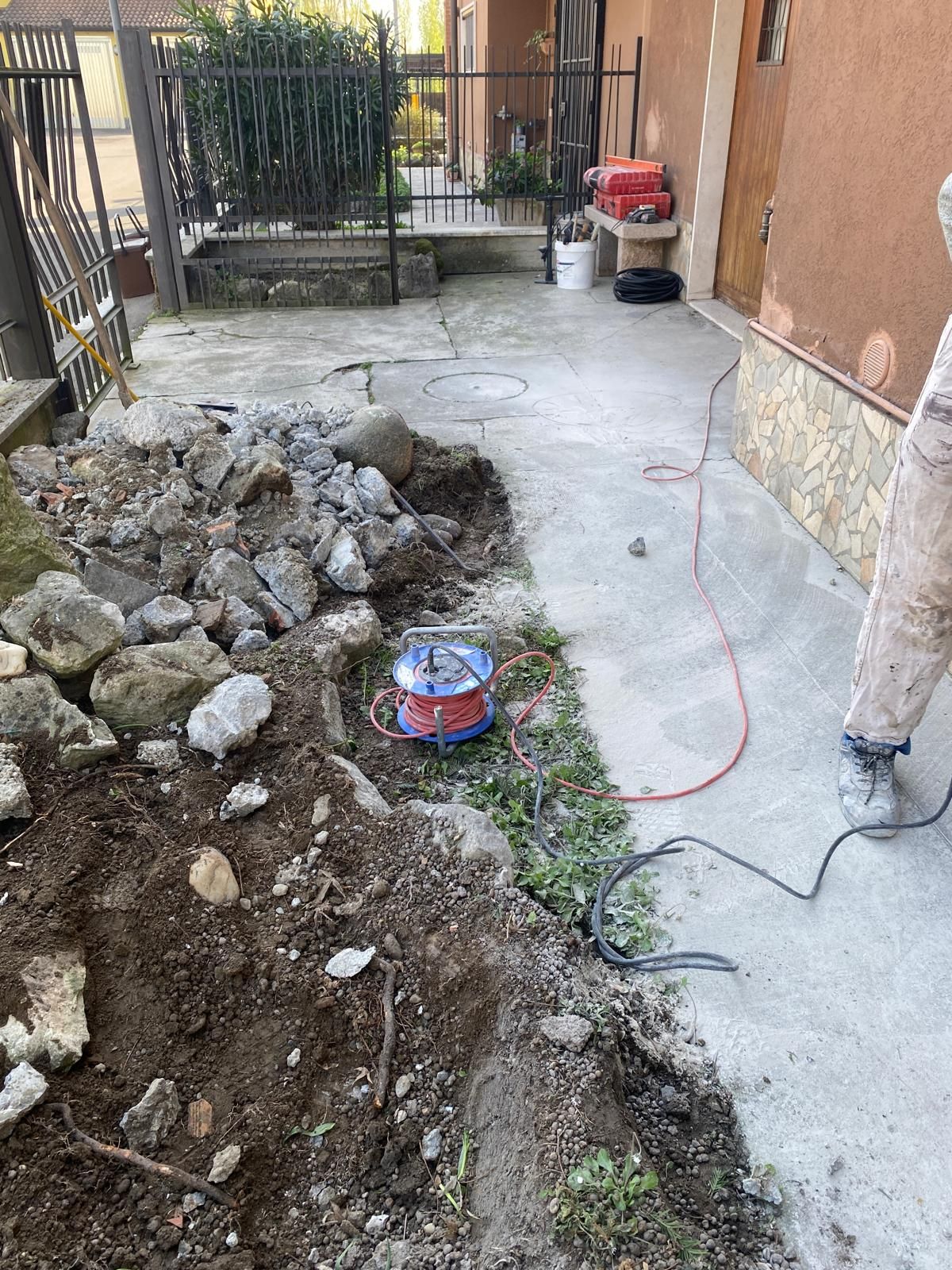 Una persona è in piedi accanto a un mucchio di terra e rocce.