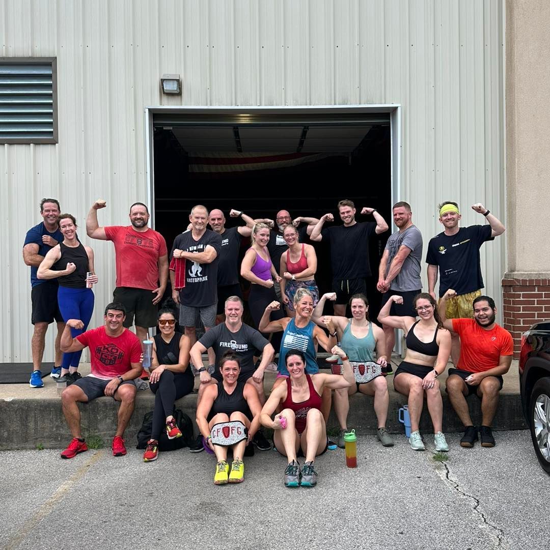 A group of people are posing for a picture in front of a building.