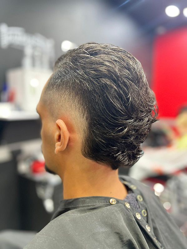 A Man With Faded Cut is Getting His Hair Cut at a Barber Shop — Hair Obsession Barber in Nightcliff, NT