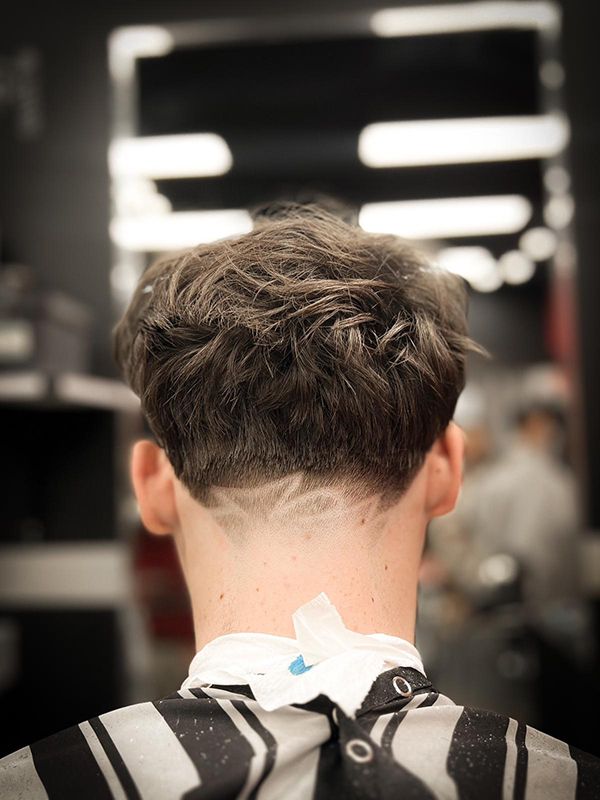 A Man With Stylish Razor Cut is Getting His Hair Cut at a Barber Shop — Hair Obsession Barber in Nightcliff, NT