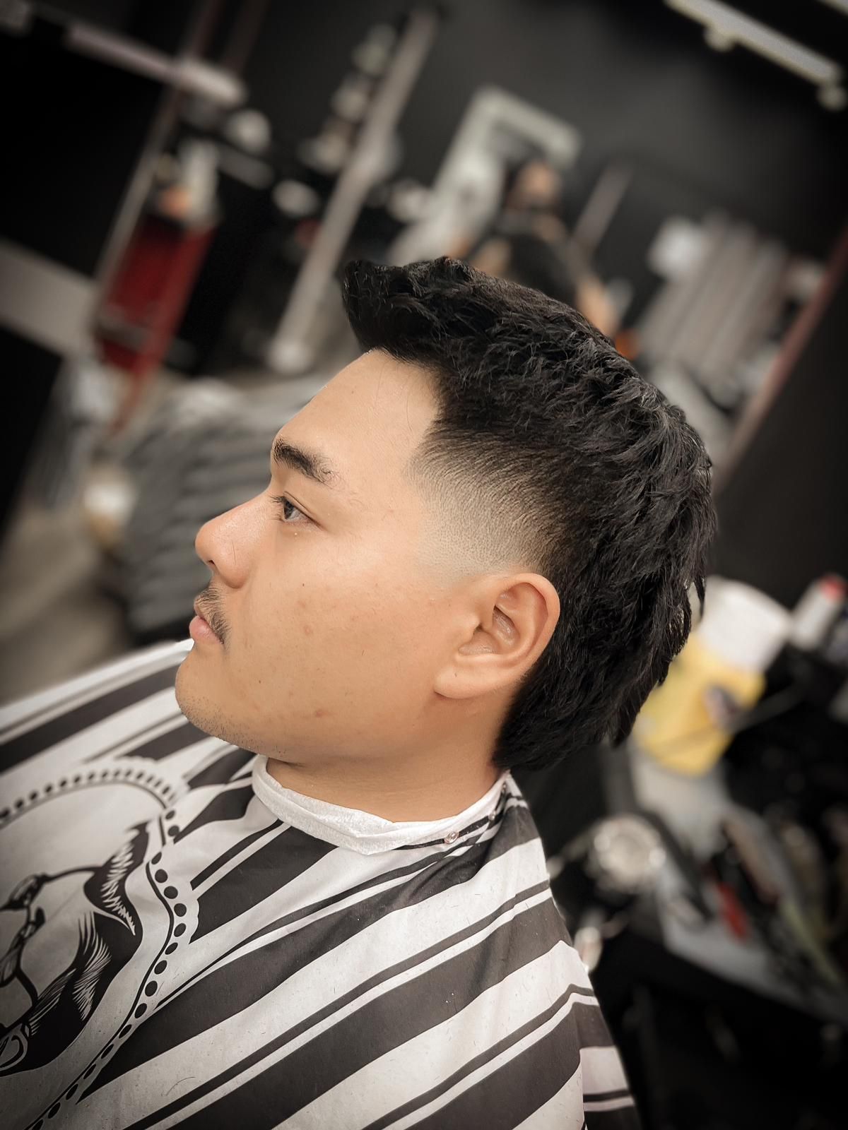 A Well-Groomed Man Is Getting His Hair Trimmed at a Barber Shop — Hair Obsession Barber in Nightcliff, NT