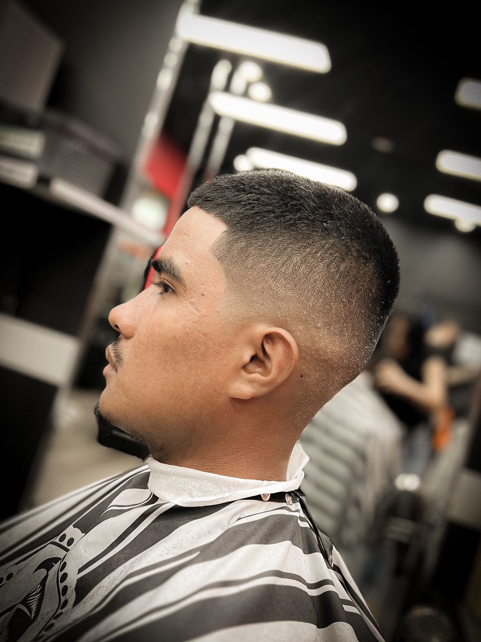 A Barber Is Giving a Haircut to a Man With Trendy Hair — Hair Obsession Barber in Nightcliff, NT