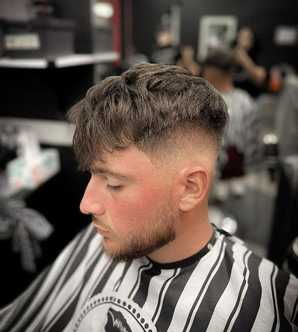 A Man With Brown Hair is Getting His Hair Cut at a Barber Shop — Hair Obsession Barber in Nightcliff, NT