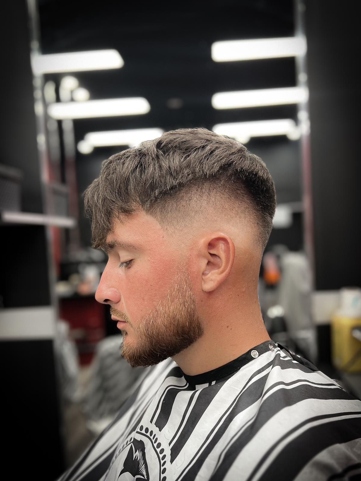A Bearded Gentleman is Sitting in the Barber’s Chair for a Haircut — Hair Obsession Barber in Nightcliff, NT
