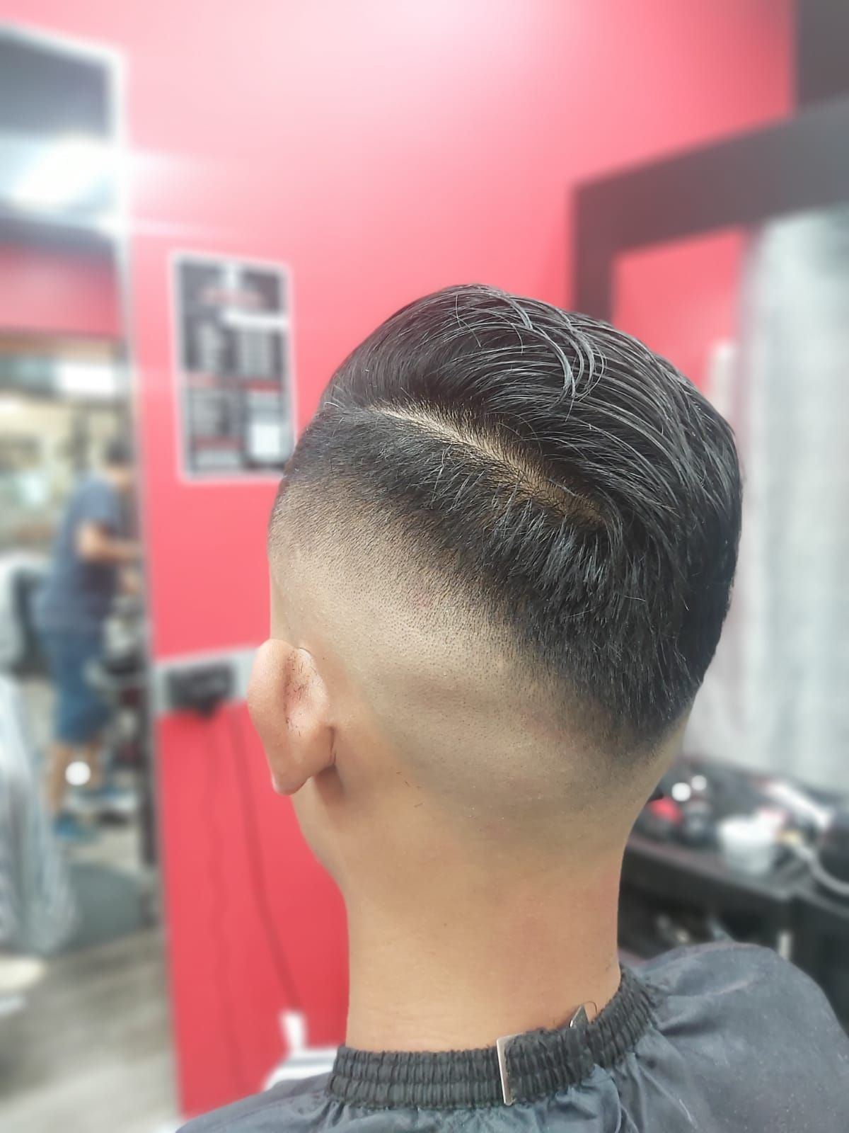 A Man With a Sleek Haircut Is in the Middle of a Trim at a Barbershop — Hair Obsession Barber in Nightcliff, NT