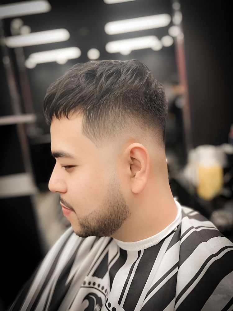 A Bearded Man Getting a Haircut at a Barbershop — Hair Obsession Barber in Nightcliff, NT