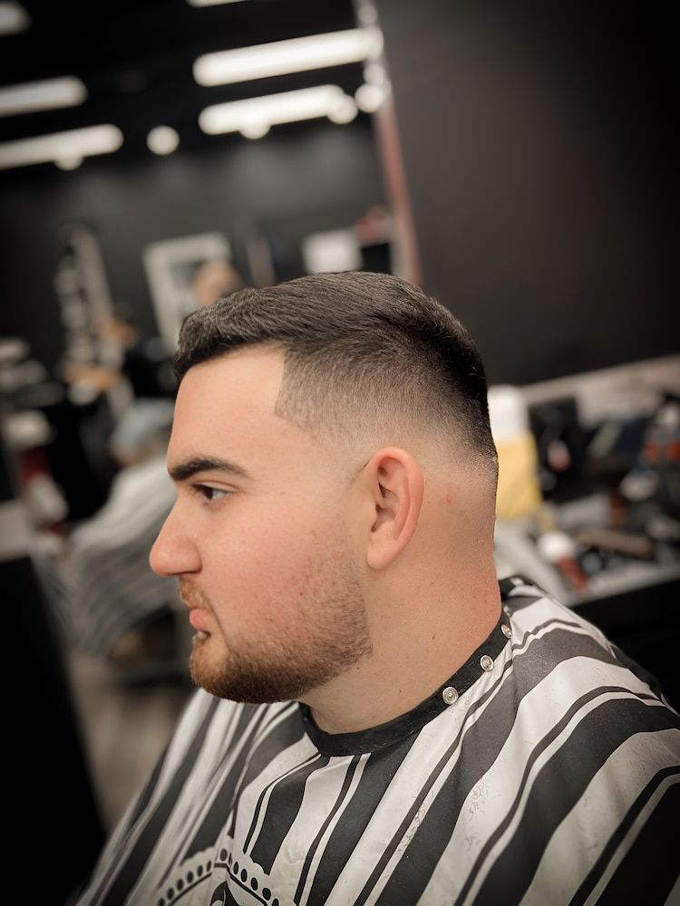 A Man is Having His Hair Trimmed at a Barbershop — Hair Obsession Barber in Nightcliff, NT