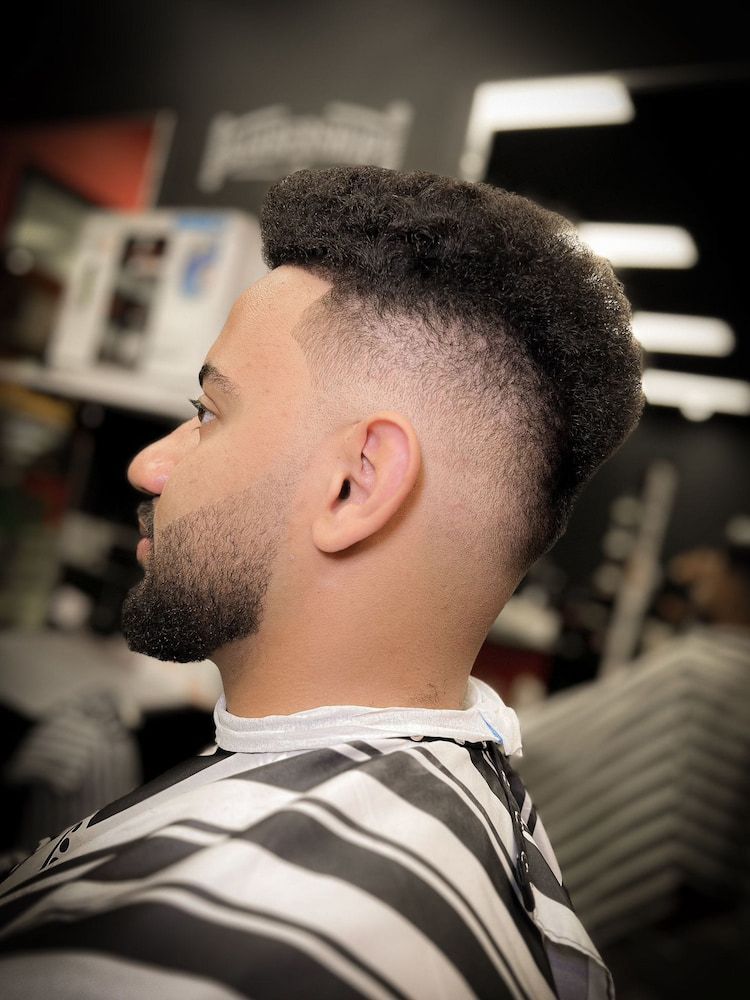 A Man With a Stylish Haircut is Receiving Grooming Services at the Barbershop — Hair Obsession Barber in Nightcliff, NT