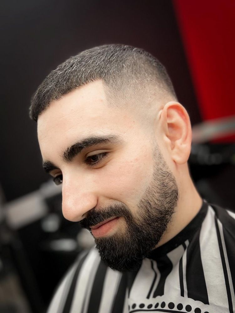 A Man With a Buzz Fade and Beard Trim is Getting His Hair Cut by a Barber — Hair Obsession Barber in Nightcliff, NT