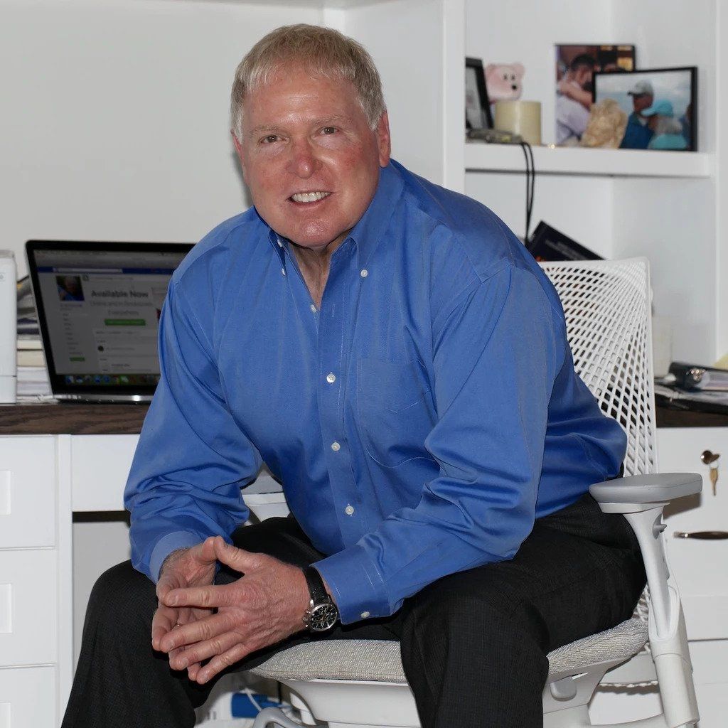 Author, Dr.Ken Druck, sitting at a desk