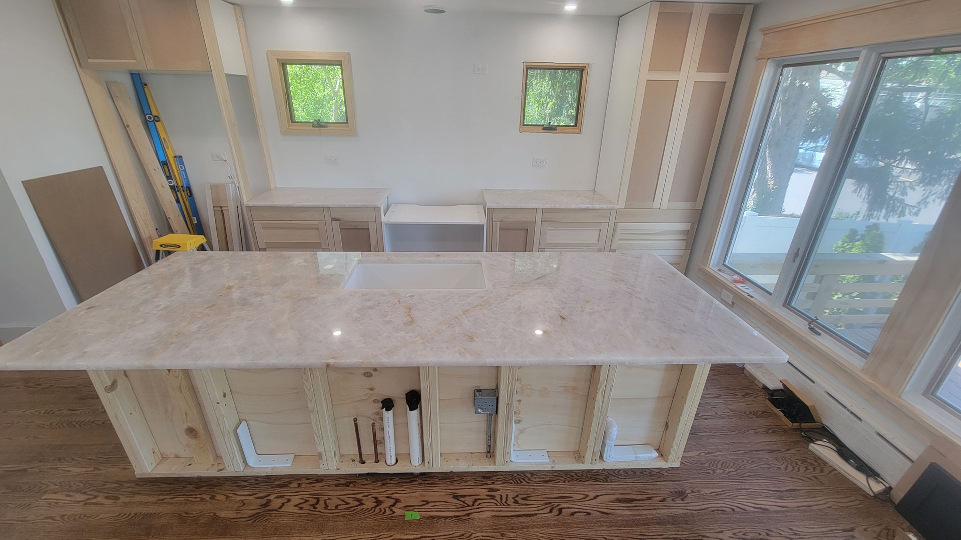 A bathroom with two sinks , two mirrors and a tub.