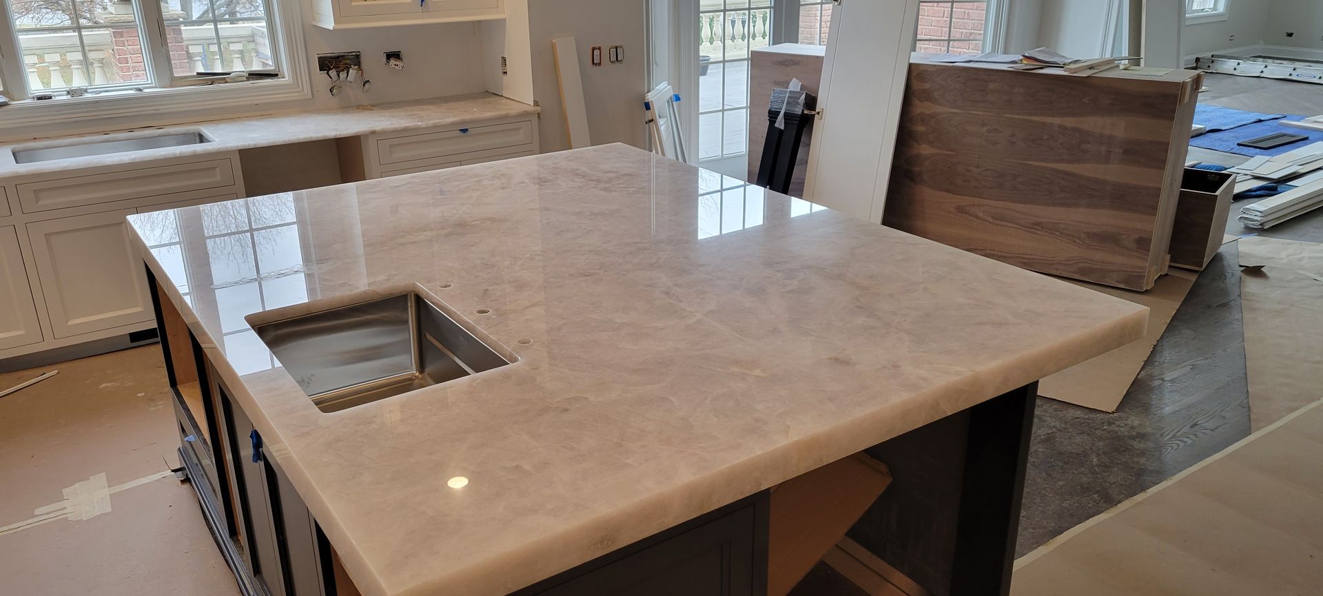 A kitchen with a large island and a sink.