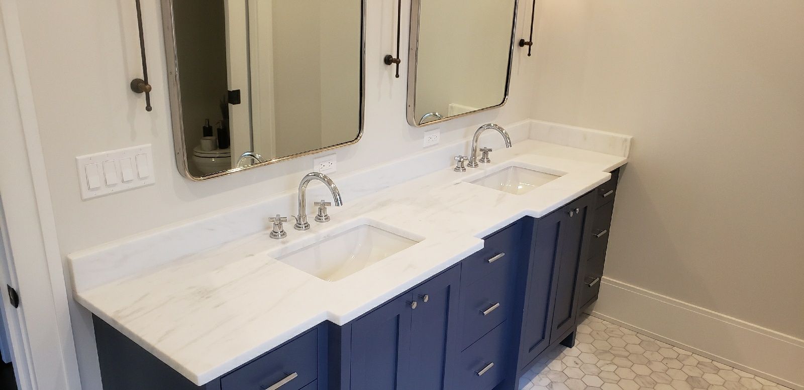 A bathroom with two sinks and two mirrors.