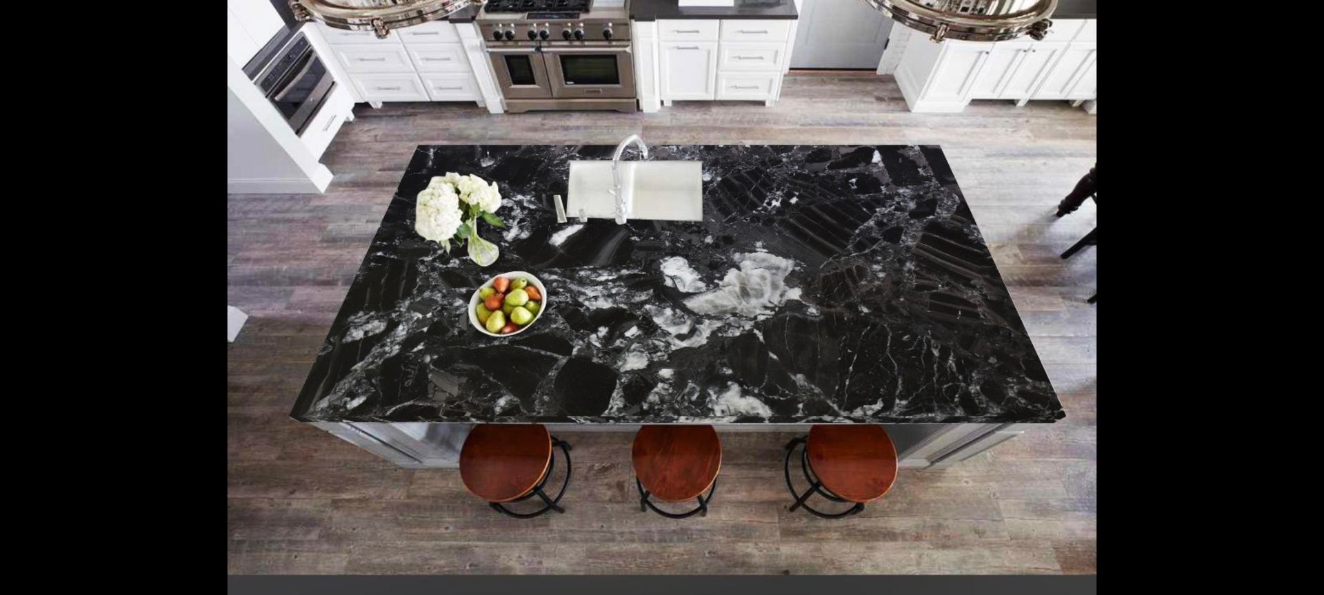 An aerial view of a kitchen with a black granite counter top.