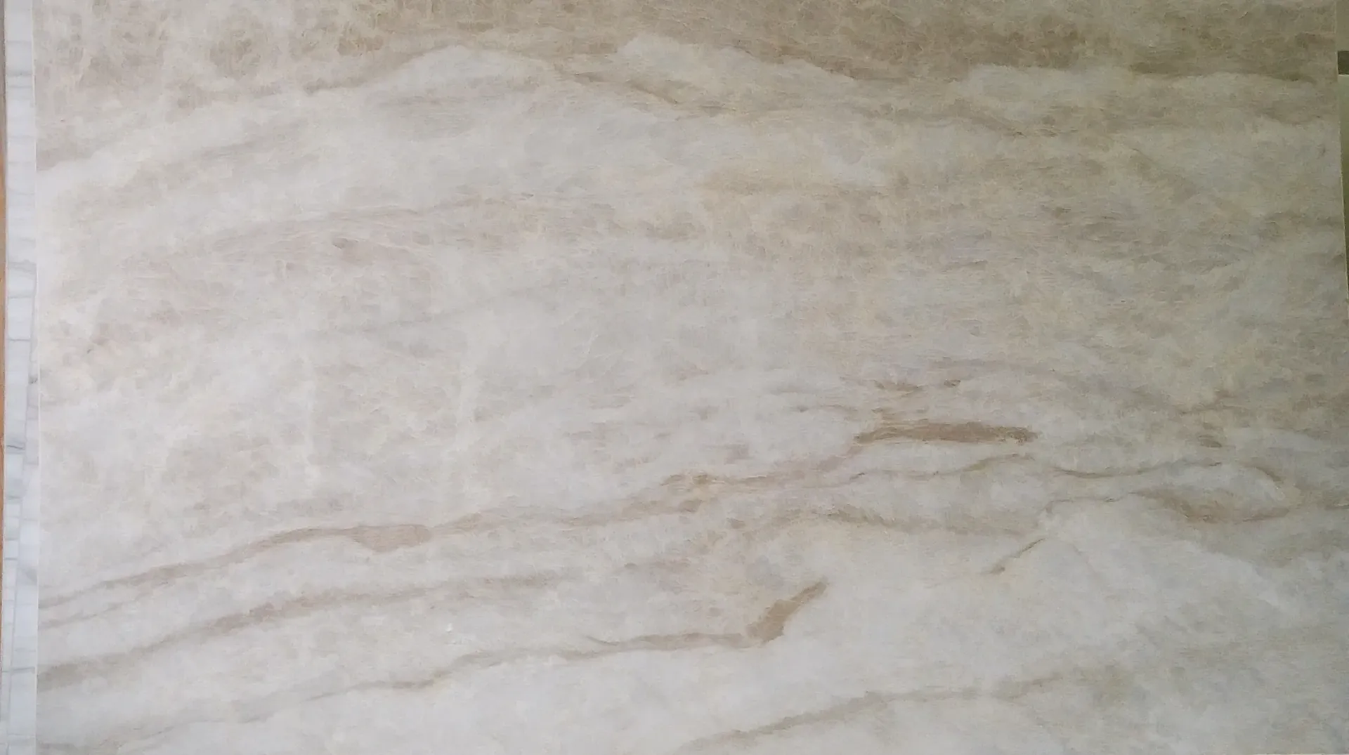 A close up of a white tile with a marble texture.