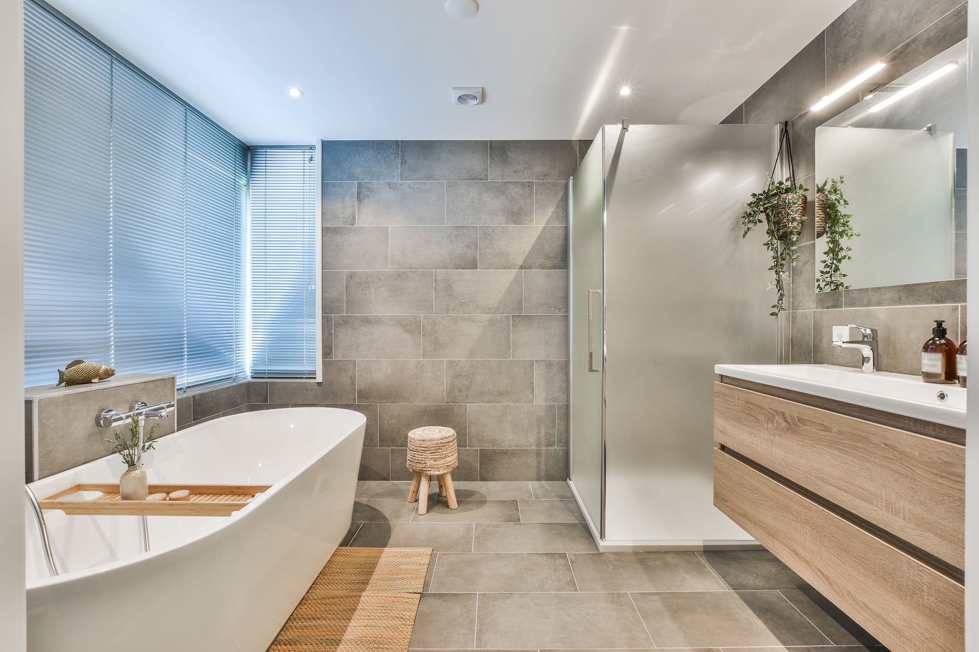 A bathroom with a bathtub , sink , and shower.