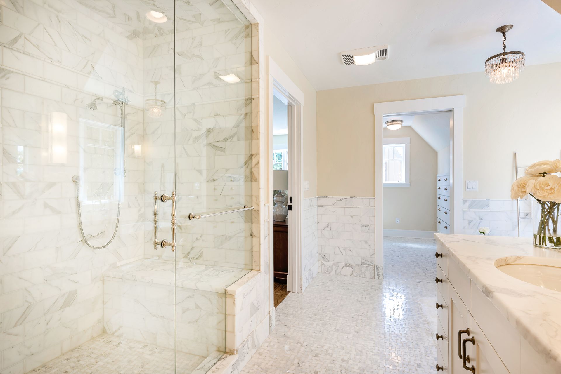 A bathroom with a walk in shower and a sink.