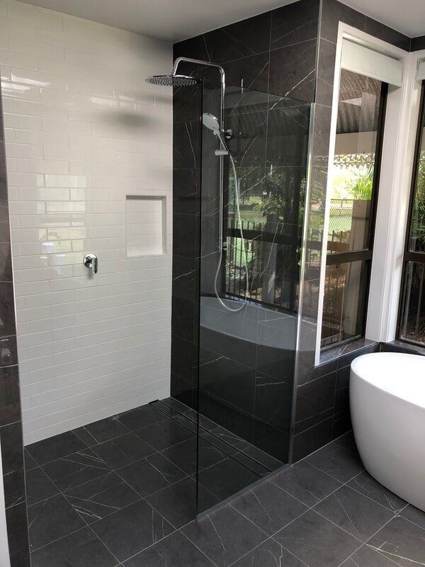A Bathroom With a Walk in Shower and a Bathtub — Rooney Glass in Coffs Harbour, NSW