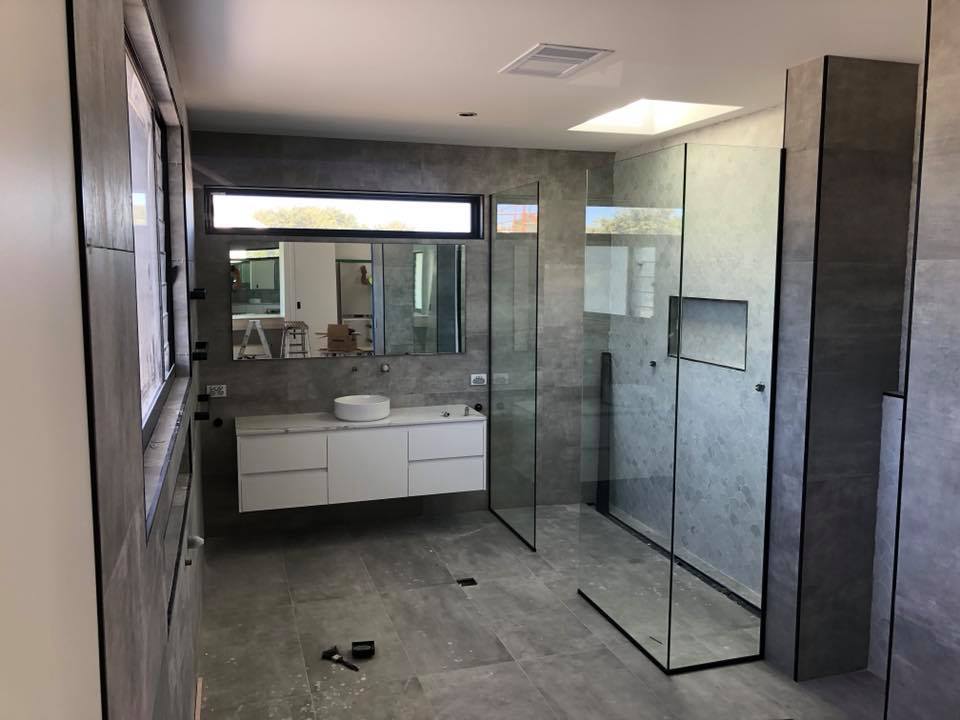 Bathroom With Shower And Tiled Floor — Rooney Glass in Coffs Harbour, NSW