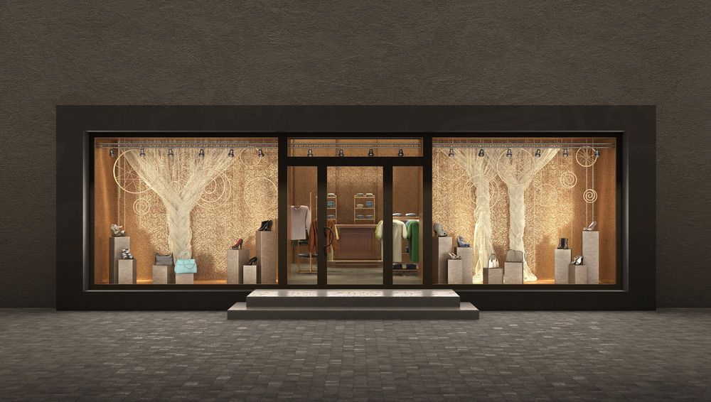 Shopfront with display of luxury items; neutral colors, gold accents.