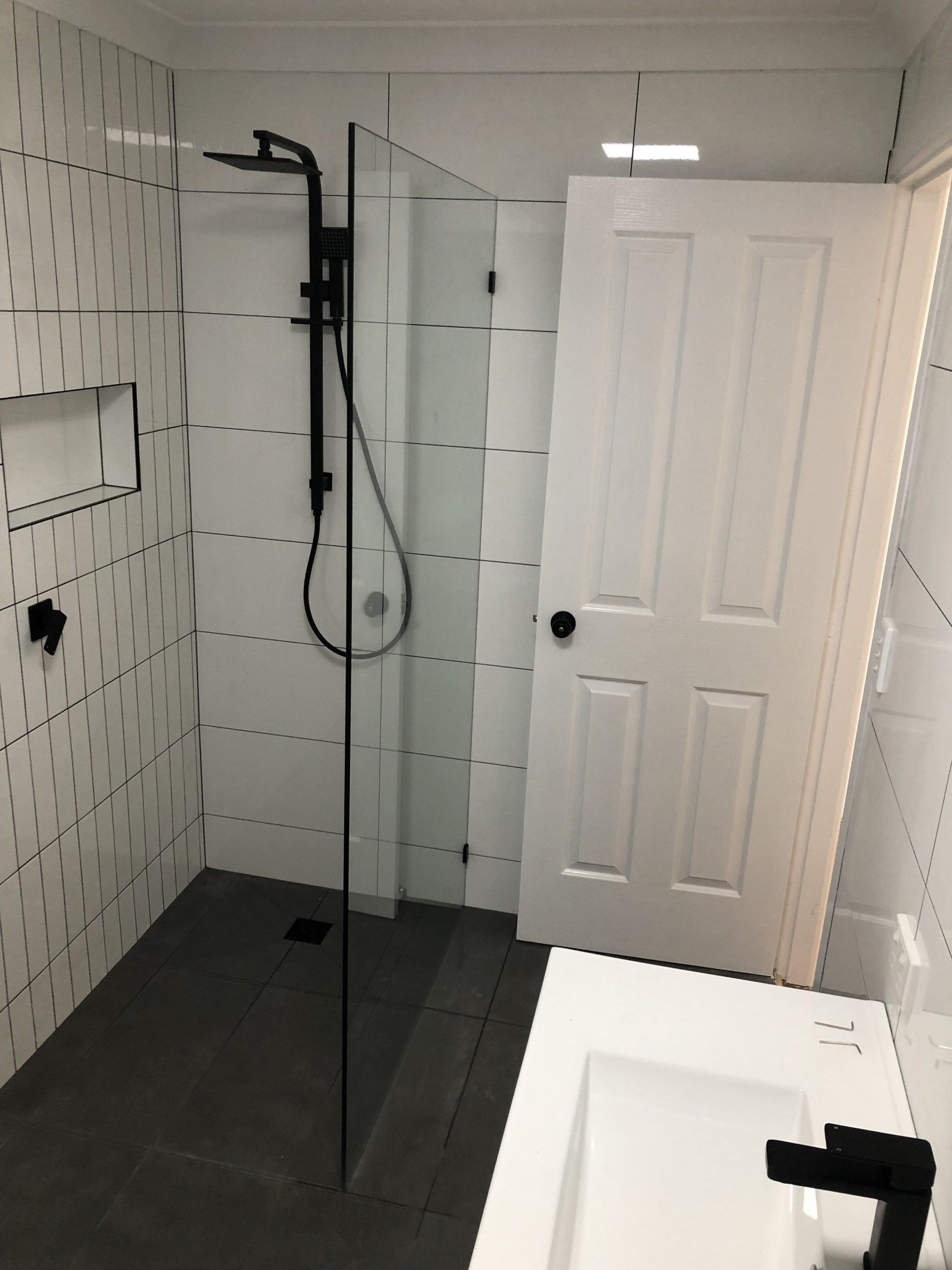 A Bathroom With a Walk in Shower and a Sink — Rooney Glass in Coffs Harbour, NSW