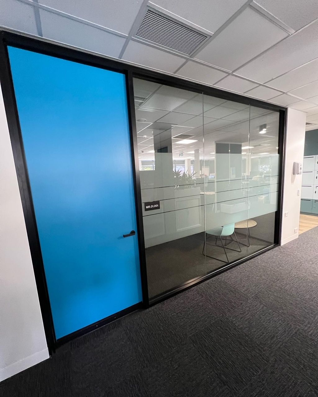 A Blue Door is Between Two Glass Walls in an Office — Rooney Glass in Coffs Harbour, NSW