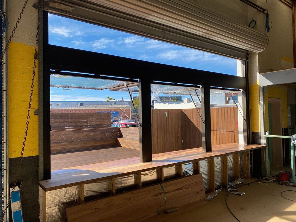 Building Under Construction With A Large Window — Rooney Glass in Coffs Harbour, NSW