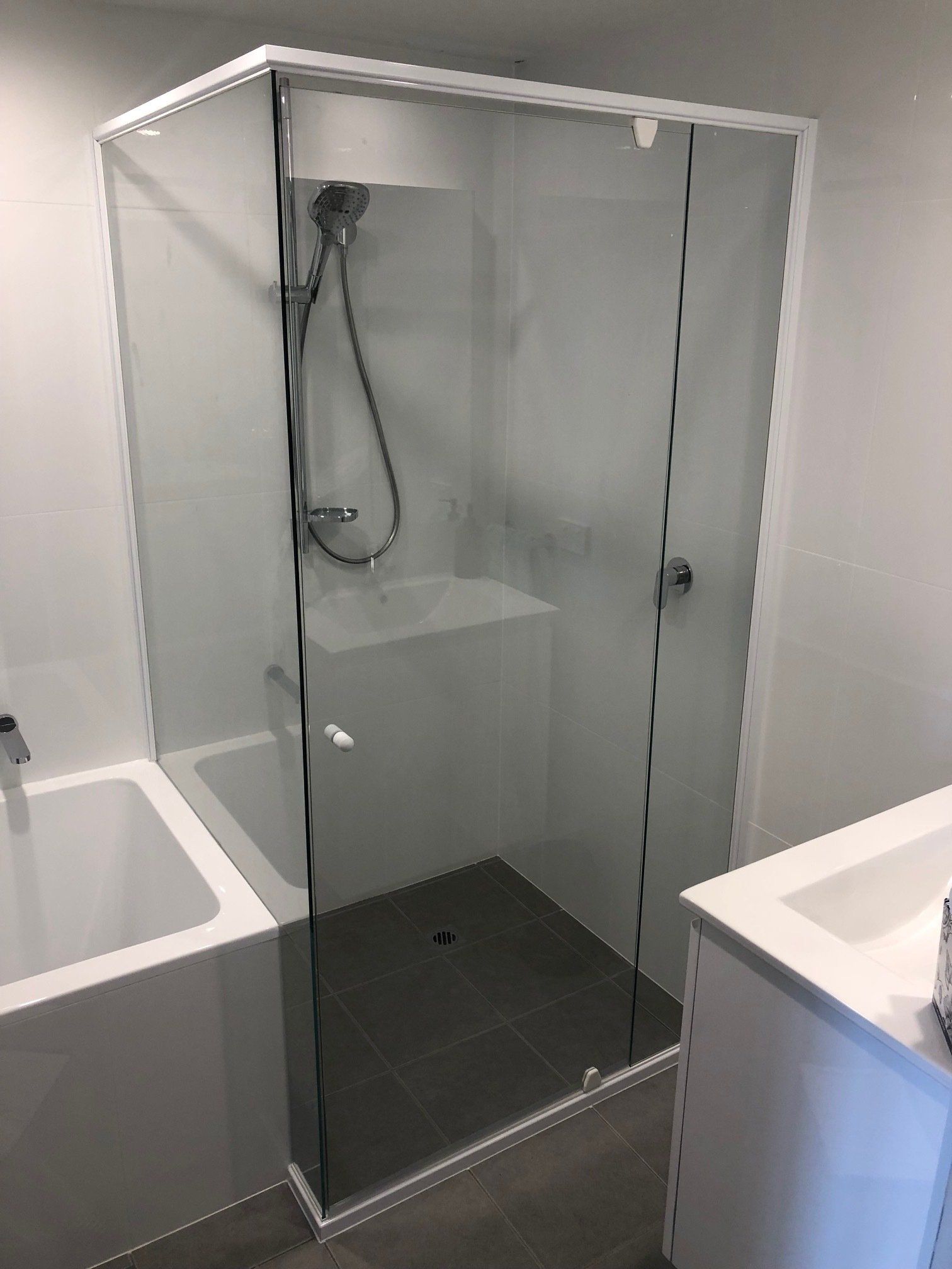 Bathroom With Bath Tub, Shower And Sink — Rooney Glass in Coffs Harbour, NSW