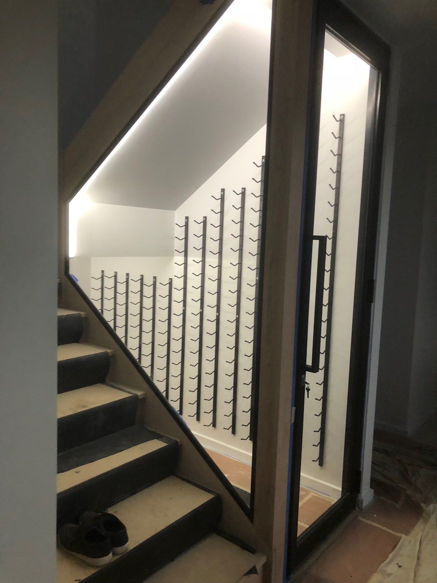 A Staircase Leading Up to a Wine Cellar With a Glass Door — Rooney Glass in Coffs Harbour, NSW