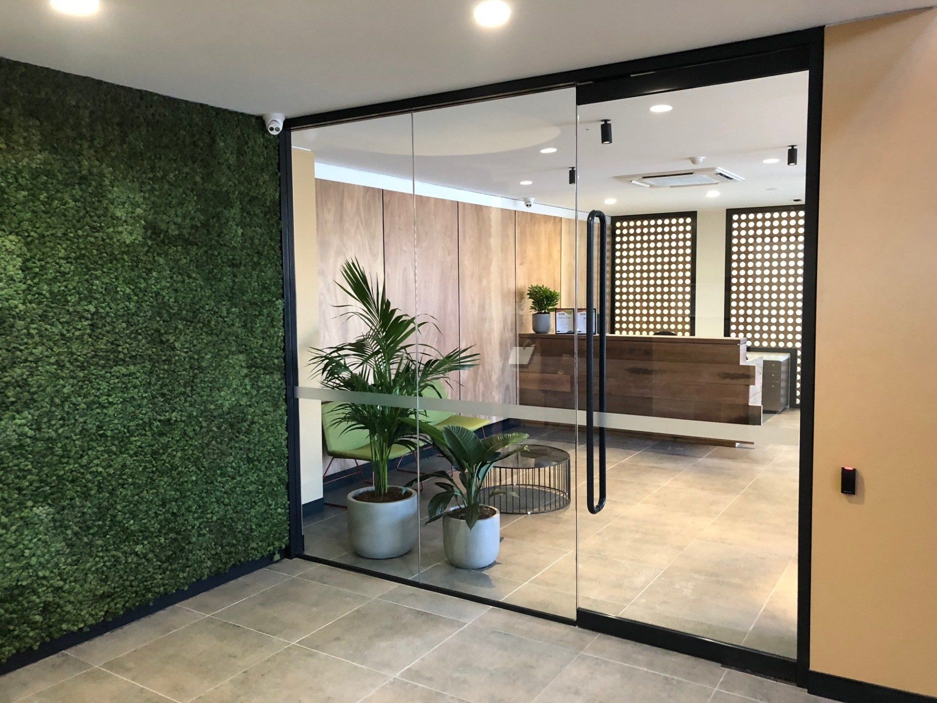 A Room With a Glass Door and a Green Wall — Rooney Glass in Coffs Harbour, NSW