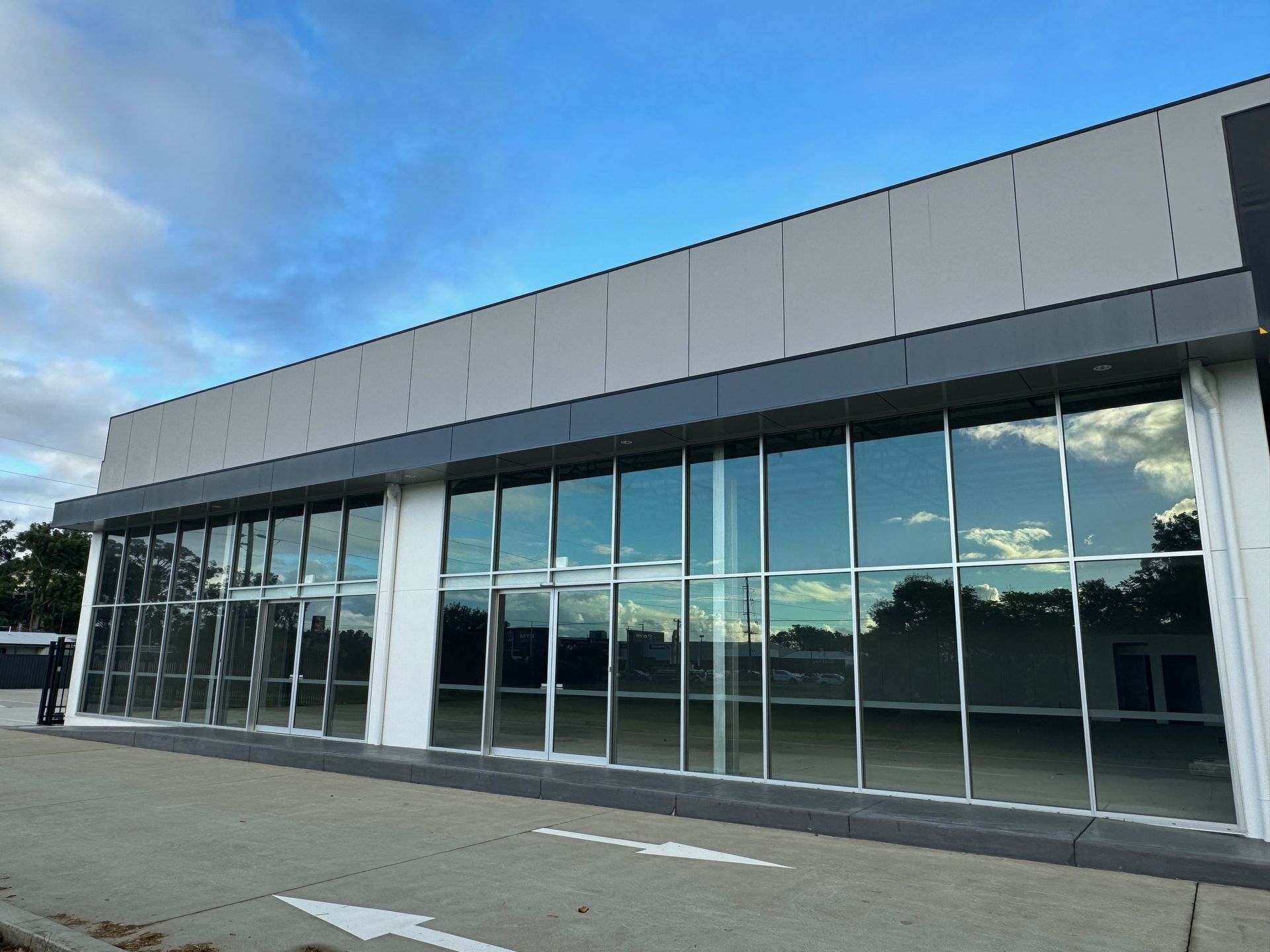 A Large Building With a Lot of Windows and a Blue Sky in the Background — Rooney Glass in Coffs Harbour, NSW