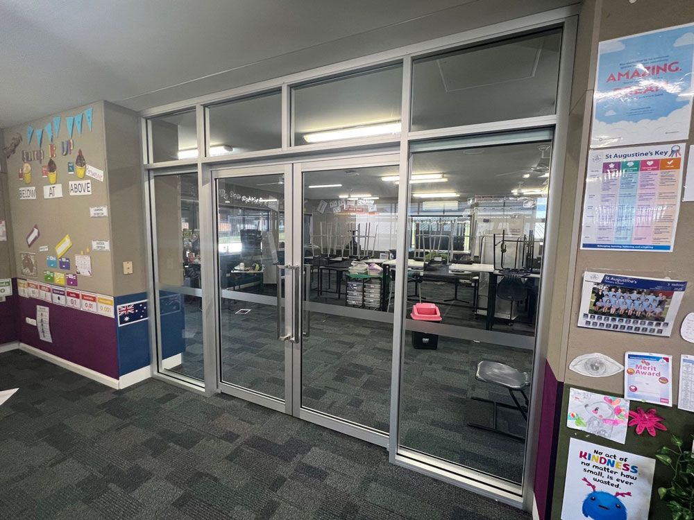 Hallway With A Lot Of Windows And Posters On The Wall — Rooney Glass in Coffs Harbour, NSW