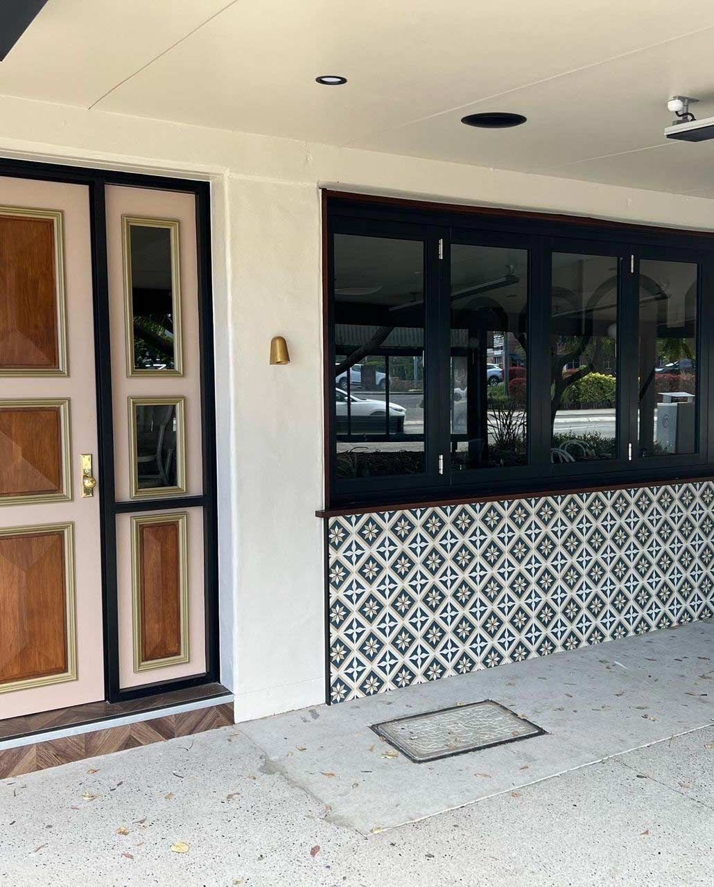 A white building with a wooden door and windows — Rooney Glass in Coffs Harbour, NSW