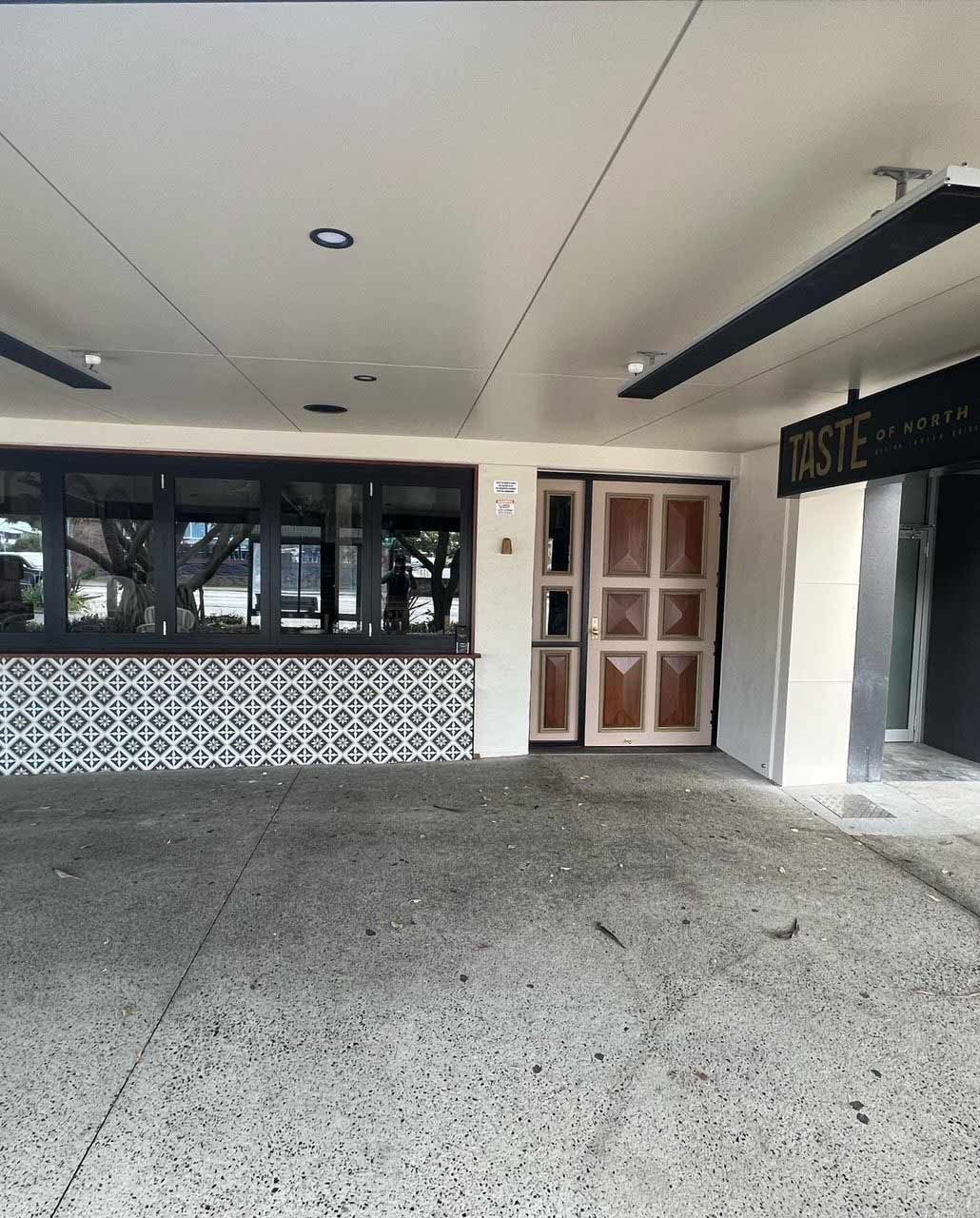 Large Building With A Lot Of Windows And A Door — Rooney Glass in Coffs Harbour, NSW