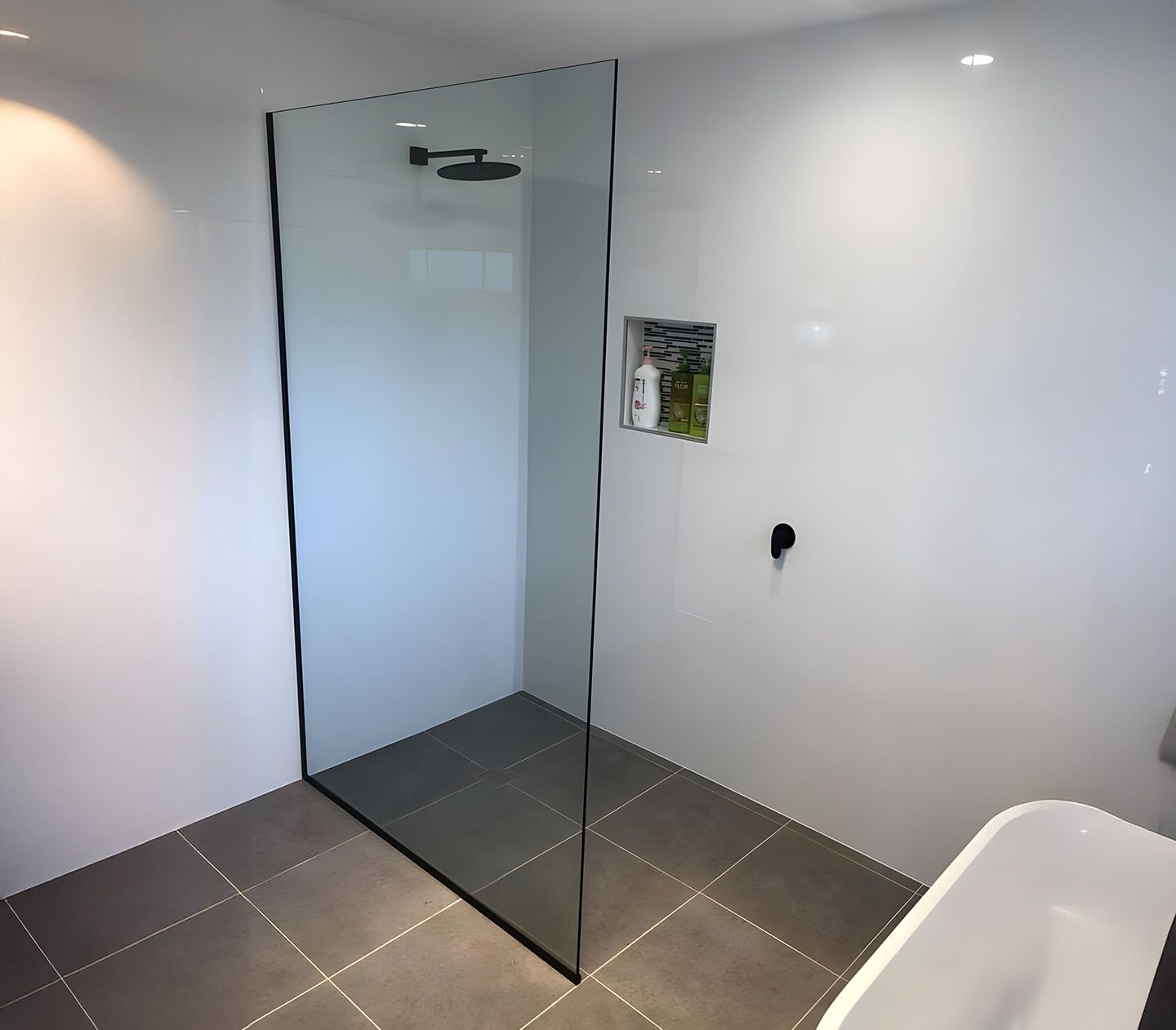 Frameless glass shower screen with modern bathroom design