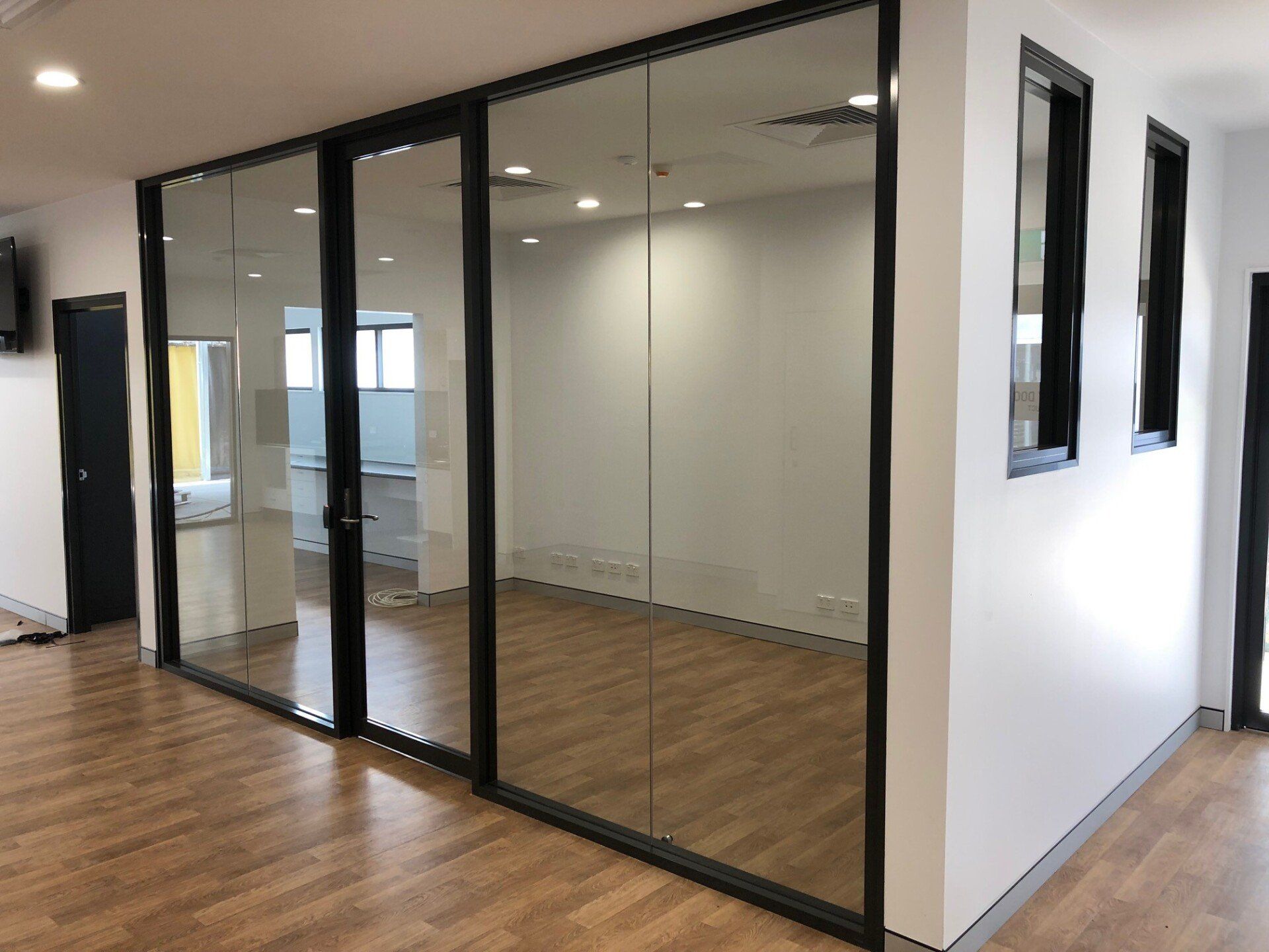 A Room With a Lot of Glass Doors and Windows — Rooney Glass in Coffs Harbour, NSW