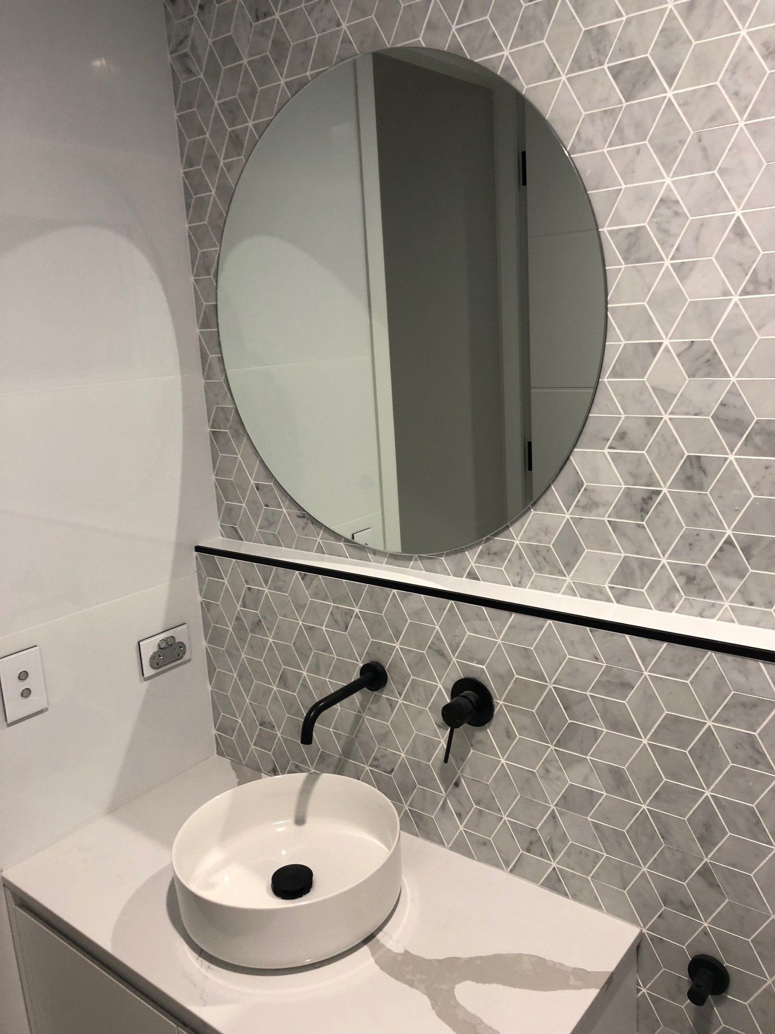 A Bathroom With a Sink and a Round Mirror — Rooney Glass in Coffs Harbour, NSW