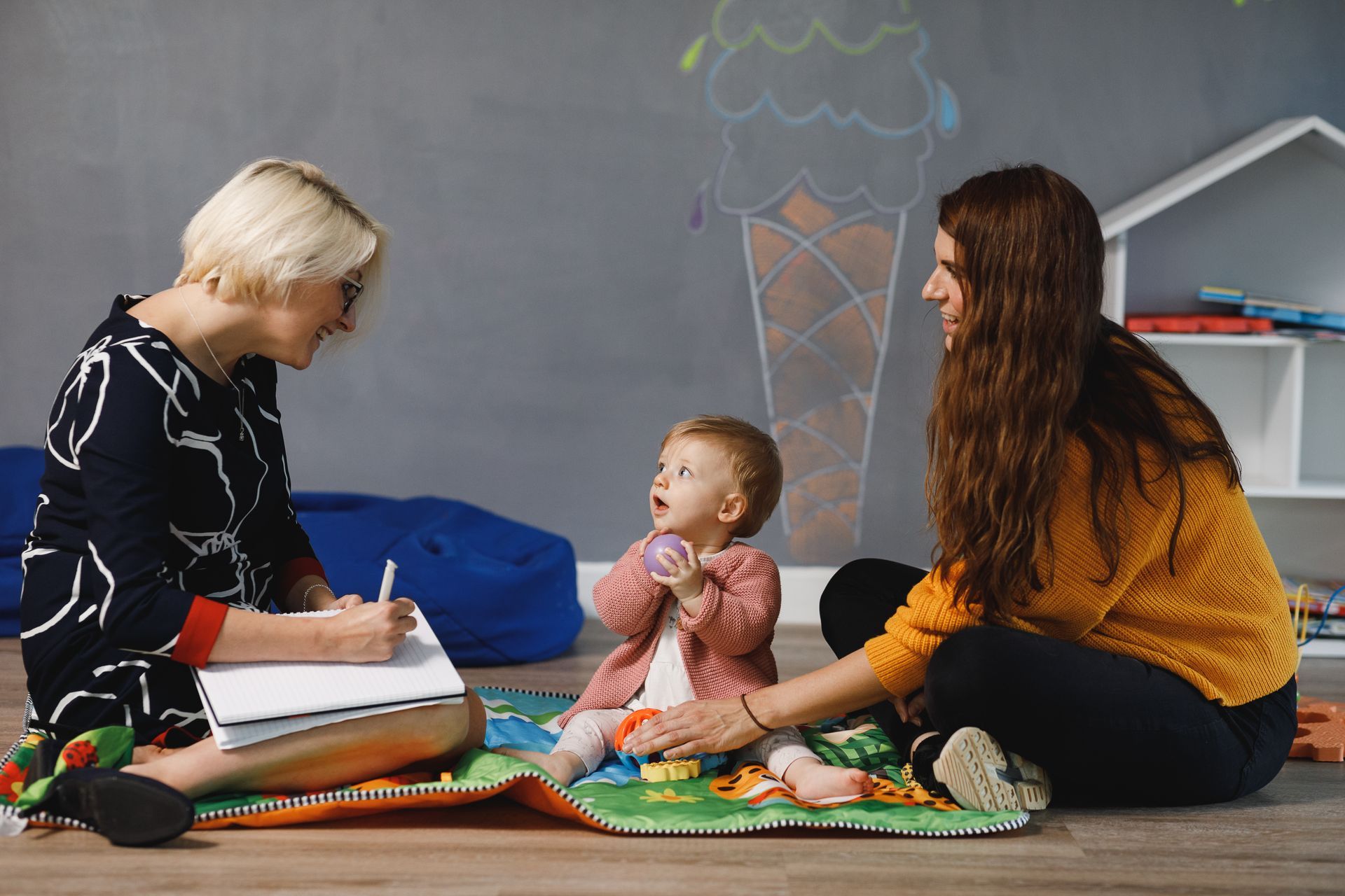 Ultrasound images of a fetus, in black and white and 3D color, on a textured white and gray background.