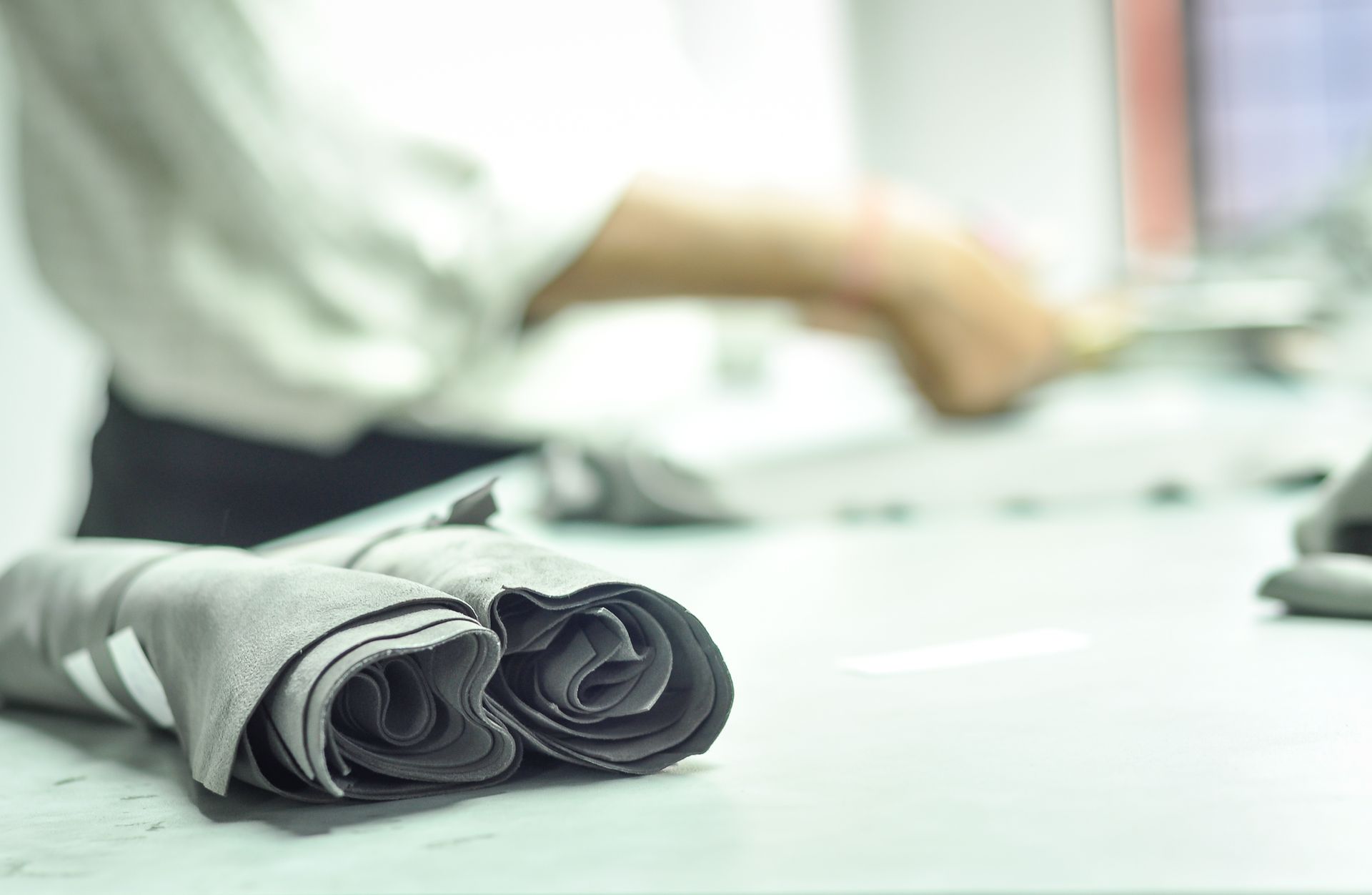 A close up of a napkin on a table with a person in the background.